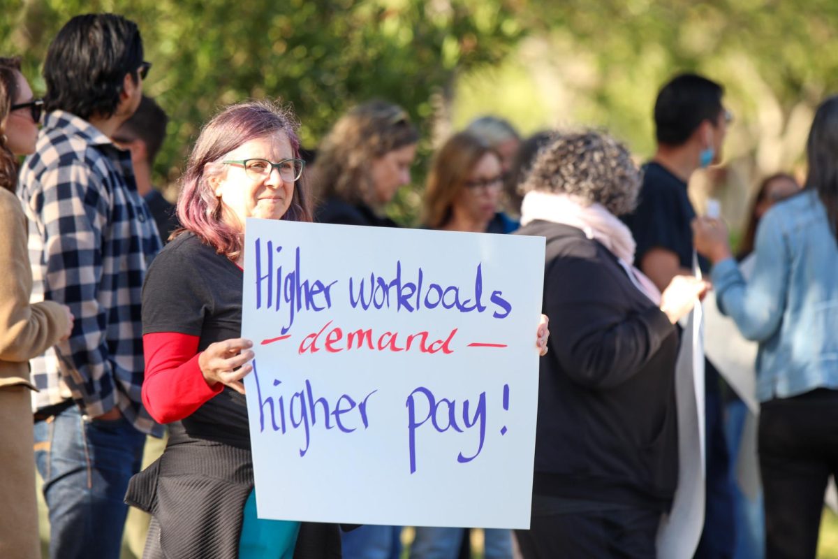 PAEA members protests outside thre district office.  “We don’t want to lose (educators) to districts that pay higher,” PAEA President Teri Baldwin said. “We want to attract and retain the best educators for our students.”